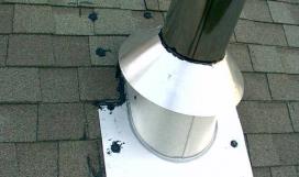 Metal storm collar and pipe flashing on roof